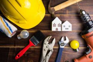 Hard hat, tools, and miniature buildings for school facility management and repair