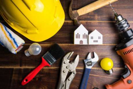 Hard hat, tools, and miniature buildings for school facility management and repair