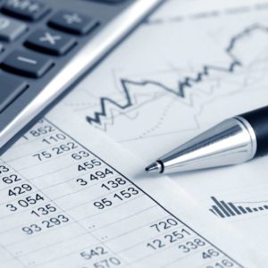 Financial spreadsheet with calculator and pen.
