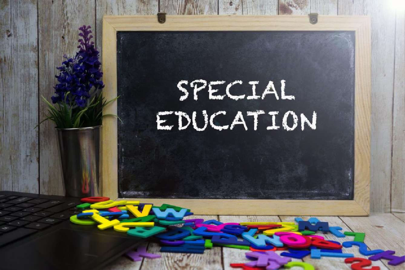 Chalkboard with 'SPECIAL EDUCATION' written on it, with colorful letters and flowers