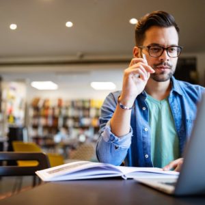 Student preparing exam and learning lessons in school library