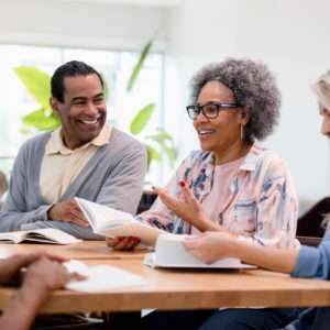 The group member discusses her review of the book with her friends.