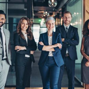 Multi-ethnic group of business persons standing side by side