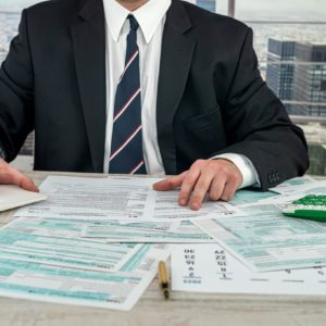 businessman working with documents 1040 tax form in office. Concept of accounting financial annual report